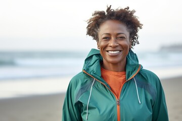 Portrait of smiling african american woman in sportswear on beach