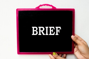 Brief text or word written on blackboard or  black chalkboard held with hand in white background.