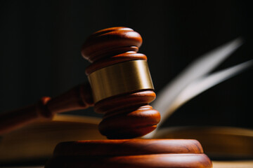 Justice and law concept.Male judge in a courtroom with the gavel, working with, computer and...