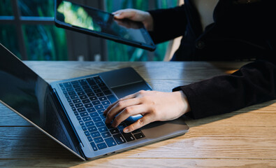 close up hands multitasking man using tablet, laptop and cellphone connecting wifi