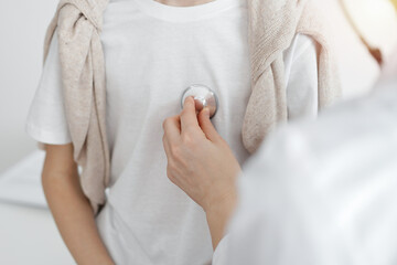 Doctor is examining a kid patient with a stethoscope. Perfect health concept in medicine