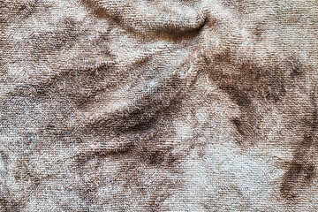 A crumpled piece of dirty, stained microfiber. Up close