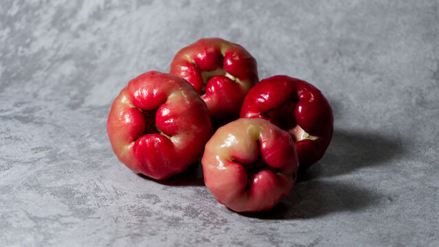 Arranged red wax apple or rose apple (Jambu air). Isolated on gray background.