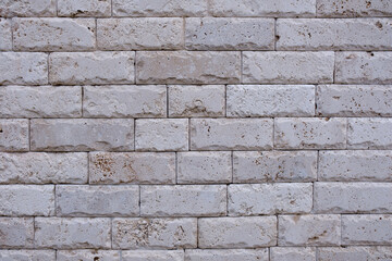 The texture of a light tile with chipped edges, similar to marble.