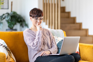 Pensive woman thinking about creative ideas using internet to inspiration