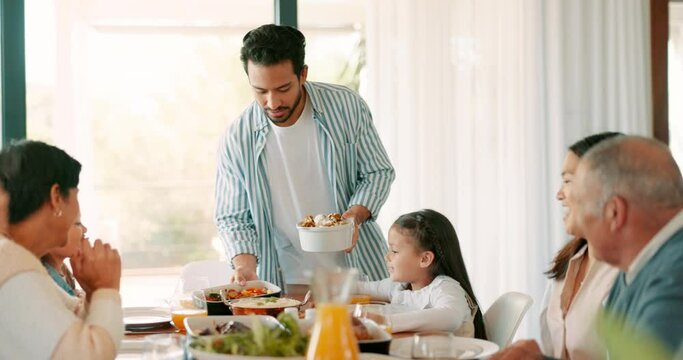 Thanksgiving, food and a man serving his family while eating at home together for bonding in celebration. Love, lunch or brunch with a father carrying a dish to the dining room table during a holiday