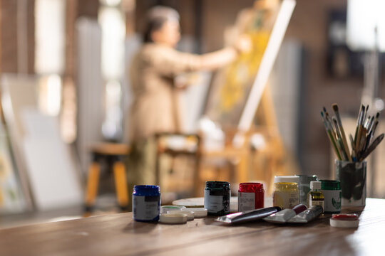 The artist paints seriously in the studio