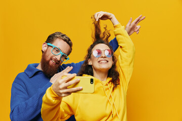 Woman and man funny couple with phones hand social networking and communication crooked do selfies...