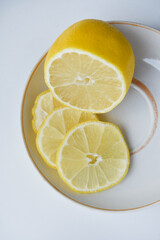Yellow juicy lemons cut on a plate. Juicy juice of chopped lemons.