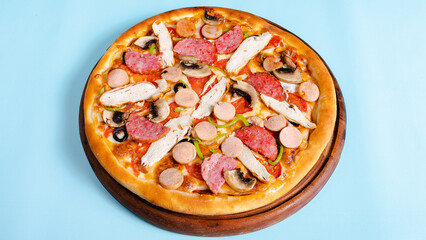 Pizza with chicken, sausages, mushrooms and olives