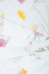 The Stack of different Dried Flowers Handmade Recycled Paper.