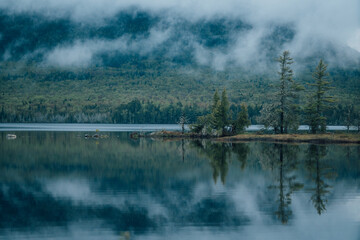 Fototapeta na wymiar Trees Reflected on Pond in Mountains