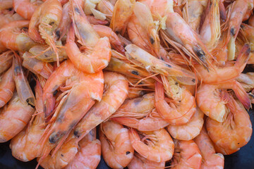 A Close-up shot of a platter of cooked fresh shrimp with garlic bits that is part of the seafood boodle fight in the Philippines