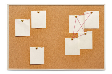 Blank paper notes are pinned to a cork board. The concept of detective investigation. Copy space.