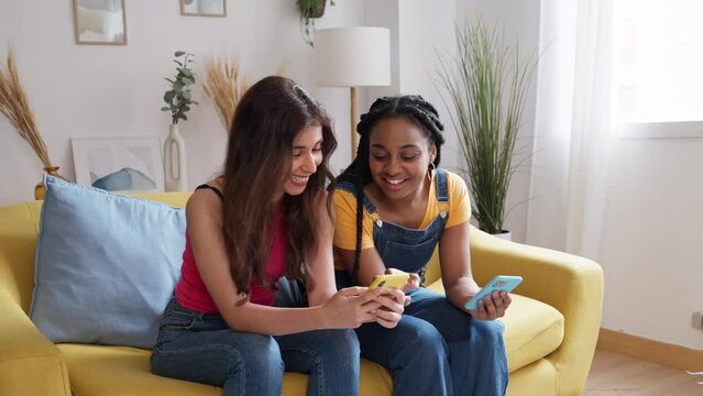 Roommates using cell phone at home.