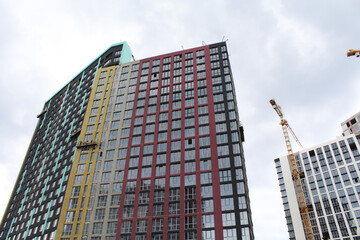modern office building. facade of a new modern building and the construction of a new building with cranes 