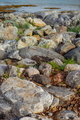 vertical view of sea bay lake surrounded by mountains sunny day.