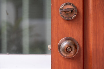 Old metal door knob on wooden door
