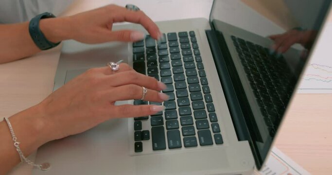 Cropped close up image young woman freelancer hands typing on laptop, businesswoman communicate online with her business group to make new business, surfing browsing the Internet Slow motion