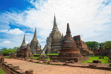 Fototapeta premium Three pagodas in an ancient Buddhist temple called Wat Prasrisanpetch in Ayutthaya historical park under noon sun light, public domain