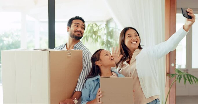 Parents, kid and video call at new home with boxes, wave and hello for communication, live stream and moving. Father, mother and daughter with webinar, contact and chat with cardboard pack in house