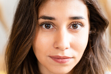 Fototapeta premium Young woman with long brown hair and a captivating gaze.