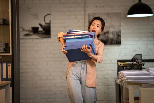 Youth career women hold a stack of folders