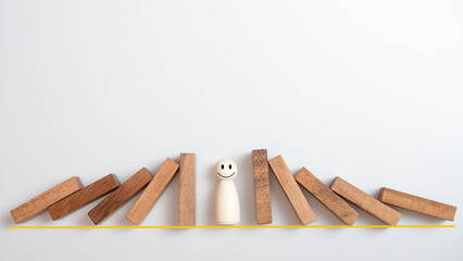 Risk management concept. Wooden block stopping dominoes effect for business.