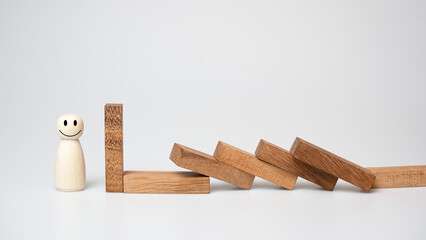 Risk management concept. Wooden block stopping dominoes effect for business.