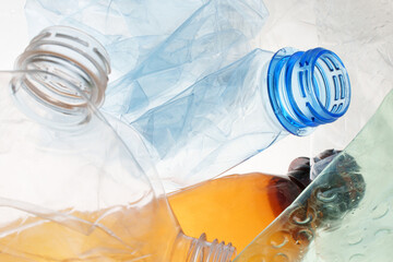 Transparent plastic bottle crumpled plastic recycling waste sorting. Pile of bottles PET recycling...