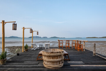 Obraz premium Outdoor seating and bar counter on the terrace, with view of the sea on the background