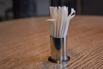 Photo of metal stand with toothpicks on table.
