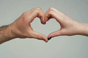 Female and male hands in form of heart. Hands in shape of love hearts. Heart from hands. Love,...