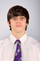 passport type picture of a young man with glasses