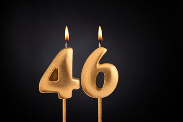 Golden candle 46 with flame - Birthday card on dark luxury background