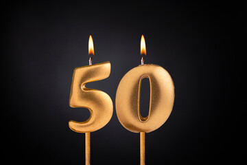 Golden candle 50 with flame - Birthday card on dark luxury background