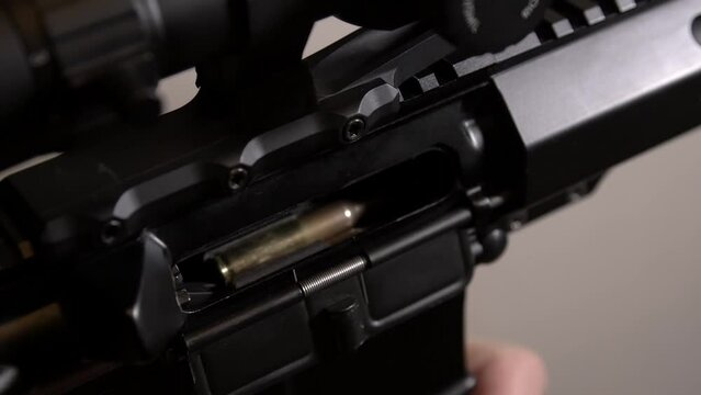 AR-15 rifle. Installing the magazine and sending the cartridge into the chamber of the rifle