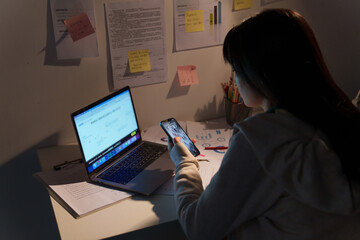 Female university student studying at night