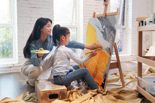 Tutor tutoring students learning painting