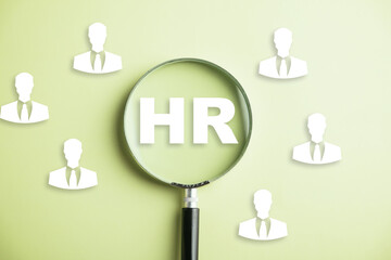 HRM in focus Magnifier glass highlights manager icon in staff icons, representing human resource...
