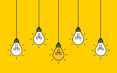 Hanging light bulbs with one glowing on yellow background. Concept of idea