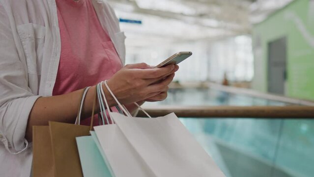 Business woman, Stylish fashionista Relaxedly holding paper bags In the store the camera is in motion Modern fashionista Shopping in a fashion store To be in the trend of fashionable things, paper cup