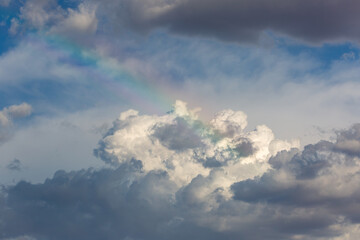 A gorgeous rainbow in the clouds, reminiscent of heaven or the rainbow bridge. Beautiful puffy...