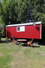 a red trailer with chairs and a table