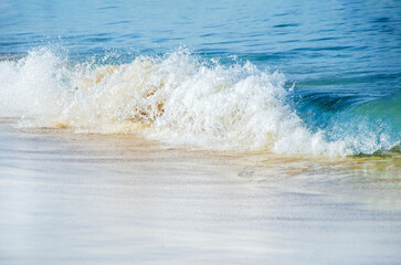 Blue sea wave, white foam, golden sand of sea coast. travel concept, summer vacation, background