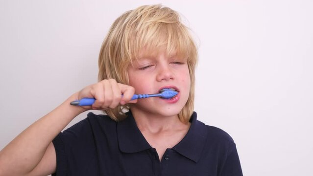 Portrait happy smiling child kid boy brushing teeth toothbrush on white , Health care, dental hygiene.