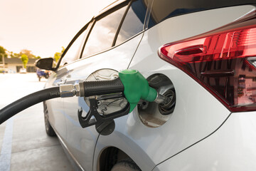 Green gas pump for refueling car on gas station.Green fuel, gasoline dispenser in station.The driver refuel at the petrol station.Save energy concept.