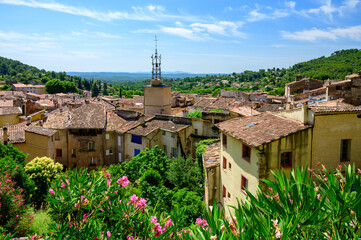 Travel destination, small ancient village Cotignac in Var, Provence, surrounded by vineyards and cliffs with troglodytes houses.