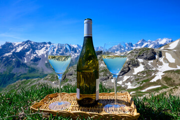 Glass and bottle of dry white Roussette de Savoie or Vin de Savoie wine from Savoy region served on...