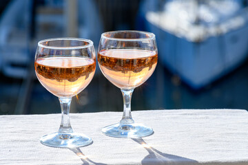Glasses of cold rose Cote de Provence wine in yacht harbour of Port Grimaud, summer vacation on French Riviera in Provence, France